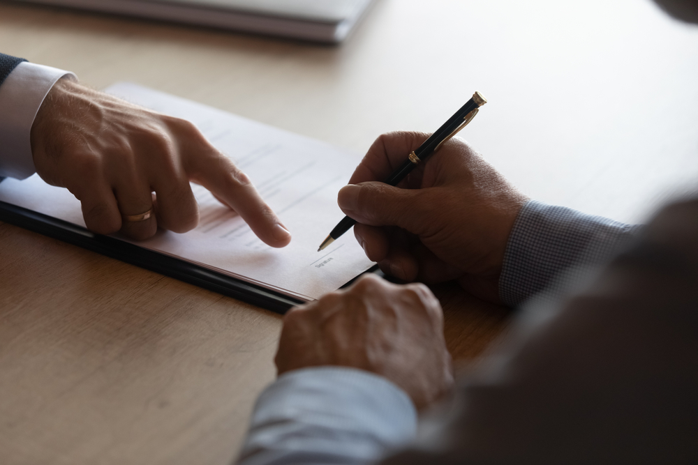 Hands,Of,Lawyer,Pointing,At,Paper,For,Businessman,Signing,Contract.